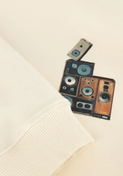 creme filling pieces sweater sweatshirt speaker wall